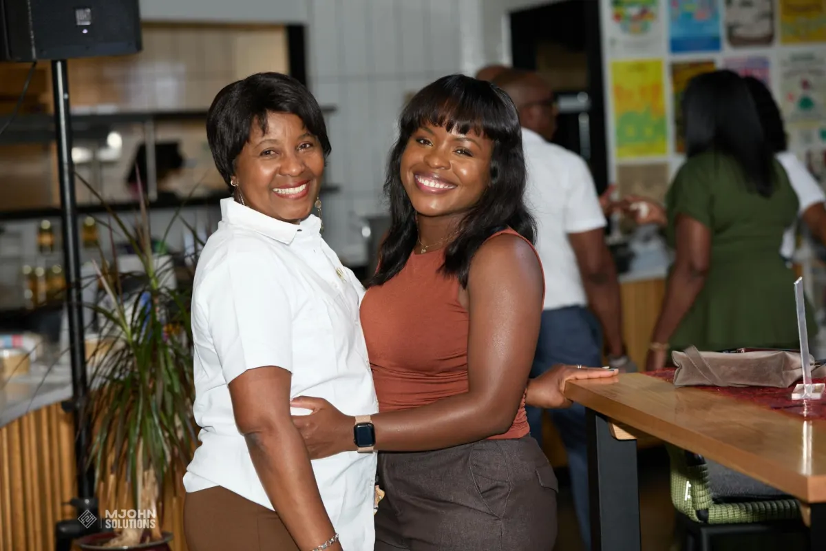 Two smiling guests posing together at the LYS & Co. Meet and Greet at Farm Fresh in Providence